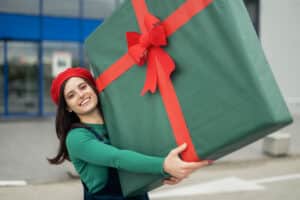 woman lifting a large holiday gift